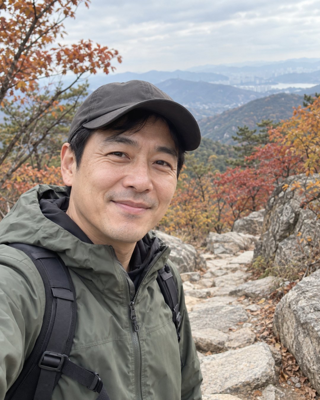 지어낸 40대 한국 남성이 산길에서 등산복 차림으로 웃고 있는 모습을 휴대폰 사진처럼 만든 AI 그림